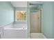 Bathroom with a soaking tub and glass-enclosed shower by the window at 946 Steadman Ter, Marietta, GA 30064