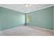 The carpeted bedroom is painted in a soothing neutral shade and has a window at 946 Steadman Ter, Marietta, GA 30064