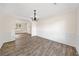 Dining room featuring wood-style flooring, a chandelier, and an arched doorway at 946 Steadman Ter, Marietta, GA 30064