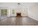 Living room featuring a brick fireplace, wood-style flooring, and natural lighting at 946 Steadman Ter, Marietta, GA 30064