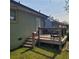 A wooden deck with steps lead to a green lawn and a house with painted siding at 2007 Mesa Se Dr, Atlanta, GA 30316