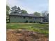 A house with a green backyard features a well-maintained lawn and space for outdoor activities at 2007 Mesa Se Dr, Atlanta, GA 30316