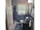Stylish bathroom with blue tile, a glass bowl sink, and modern fixtures at 2007 Mesa Se Dr, Atlanta, GA 30316