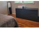 A bedroom features hardwood floors, a dresser, and a full length mirror at 2007 Mesa Se Dr, Atlanta, GA 30316