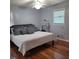 A cozy bedroom features hardwood floors, neutral walls, and a comfortable bed with decorative pillows at 2007 Mesa Se Dr, Atlanta, GA 30316
