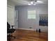 A well-lit bedroom features hardwood floors, a window, and ample space at 2007 Mesa Se Dr, Atlanta, GA 30316