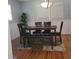 Bright dining room with hardwood floors, a modern light fixture, and a stylish dining set at 2007 Mesa Se Dr, Atlanta, GA 30316
