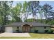 Charming single-story home with a cozy front porch and well-maintained landscaping surrounded by mature trees at 2007 Mesa Se Dr, Atlanta, GA 30316