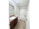 Bathroom featuring wood look floors and shower-tub combo at 2225 Bigwood Trl, Atlanta, GA 30349