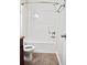 Well-lit bathroom featuring a modern tub and shower combination, paired with stylish wood-look vinyl flooring at 2225 Bigwood Trl, Atlanta, GA 30349