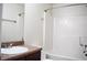 Bright bathroom features a modern tub and shower combination with wood-look vinyl flooring and vanity with a countertop at 2225 Bigwood Trl, Atlanta, GA 30349