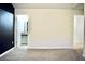 Carpeted bedroom features neutral-colored walls and access to a bathroom and additional room at 2225 Bigwood Trl, Atlanta, GA 30349
