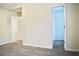 Carpeted bedroom with neutral-colored walls and an open doorway to a closet with wire shelving at 2225 Bigwood Trl, Atlanta, GA 30349