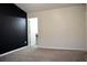 Carpeted bedroom features a bold accent wall, and door leading to an en-suite bathroom at 2225 Bigwood Trl, Atlanta, GA 30349