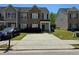 Traditional two-story townhouse featuring brick accents, tidy landscaping, and a concrete driveway at 2225 Bigwood Trl, Atlanta, GA 30349