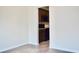 View into kitchen with rich wood cabinets, black appliances, granite countertops, and luxury vinyl plank flooring at 2225 Bigwood Trl, Atlanta, GA 30349