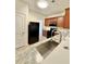 Modern kitchen featuring granite countertops, stainless steel sink, and a sleek black refrigerator and microwave at 2225 Bigwood Trl, Atlanta, GA 30349