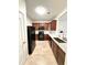 Well-lit kitchen with granite countertops, wooden cabinets, and new appliances, creating a modern cooking space at 2225 Bigwood Trl, Atlanta, GA 30349