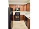 Modern kitchen with dark wood cabinets, stainless steel appliances, and light countertops at 2225 Bigwood Trl, Atlanta, GA 30349