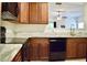 Modern kitchen with dark wood cabinets, stainless steel appliances, light countertops, luxury vinyl plank flooring and an eat-in bar at 2225 Bigwood Trl, Atlanta, GA 30349