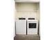 Laundry room with full-size washer and dryer and wire shelf at 2225 Bigwood Trl, Atlanta, GA 30349