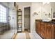 Updated bathroom featuring a glass enclosed shower, granite counters, and decorative shelving for toiletries at 225 Mystic Ridge Hl, Sandy Springs, GA 30342