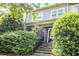 Charming home exterior featuring stone steps, a brick facade, and well-maintained landscaping with lush greenery at 225 Mystic Ridge Hl, Sandy Springs, GA 30342