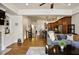 Open-concept living area with hardwood floors, seamless flow to kitchen, and comfortable furnishings at 225 Mystic Ridge Hl, Sandy Springs, GA 30342