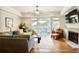 Cozy living room featuring a fireplace, outdoor access, a ceiling fan and a comfortable seating arrangement at 225 Mystic Ridge Hl, Sandy Springs, GA 30342