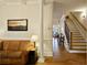 Bright living room boasts hardwood floors, stairs, detailed trim, and seamless flow to other living spaces at 225 Mystic Ridge Hl, Sandy Springs, GA 30342