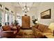 Comfortable living room featuring a coffered ceiling, large windows, and cozy seating arrangement at 225 Mystic Ridge Hl, Sandy Springs, GA 30342