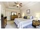 A spacious main bedroom with tray ceiling, ceiling fan, and ample natural light showcasing comfortable furnishings at 225 Mystic Ridge Hl, Sandy Springs, GA 30342