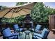 Inviting outdoor space with a stone fireplace, umbrella, and comfortable seating for relaxing and entertaining at 225 Mystic Ridge Hl, Sandy Springs, GA 30342