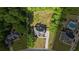 Expansive property featuring a well-maintained lawn, trees, and a lovely home with a long driveway at 1213 Blue Springs Dr, Loganville, GA 30052