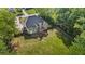 Aerial view of the back of the house with a fenced yard, lush lawn, and mature trees at 1213 Blue Springs Dr, Loganville, GA 30052