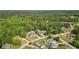 Scenic aerial view of a home nestled in a lush, green neighborhood, showcasing beautiful landscapes and swimming pools at 1213 Blue Springs Dr, Loganville, GA 30052