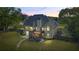 A charming home is visible, with a backyard featuring a deck, a patio, and a lush green lawn at 1213 Blue Springs Dr, Loganville, GA 30052