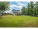 Spacious backyard featuring lush greenery, mature trees, and a private fence-lined perimeter at 1213 Blue Springs Dr, Loganville, GA 30052