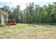 Expansive backyard featuring a wooden fence and a deck, ideal for outdoor living and entertaining at 1213 Blue Springs Dr, Loganville, GA 30052