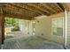 Covered patio area, providing shade and a view of the well-maintained lawn and landscaped yard at 1213 Blue Springs Dr, Loganville, GA 30052