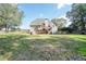 Sprawling backyard featuring a two-story home and expansive grassy area at 1213 Blue Springs Dr, Loganville, GA 30052