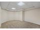 Finished basement area featuring carpeted floors, recessed lighting, and a drop ceiling at 1213 Blue Springs Dr, Loganville, GA 30052