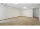 Spacious basement with carpeted floors and multiple doors for versatile use at 1213 Blue Springs Dr, Loganville, GA 30052