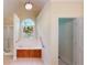 Bright bathroom features a soaking tub, stained glass window, and tiled floor at 1213 Blue Springs Dr, Loganville, GA 30052
