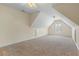Spacious bedroom featuring neutral-toned walls, plush carpeting, and a window with natural light at 1213 Blue Springs Dr, Loganville, GA 30052