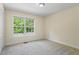 Neutral bedroom featuring large window with views, carpet and modern ceiling fan at 1213 Blue Springs Dr, Loganville, GA 30052