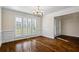 Bright dining room with hardwood floors, wainscoting, and plantation shutters at 1213 Blue Springs Dr, Loganville, GA 30052