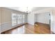 Formal dining area with hardwood floors, wainscoting detail, and a chandelier above at 1213 Blue Springs Dr, Loganville, GA 30052