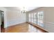 Elegant dining room with hardwood floors, wainscoting, and a large window with shutters at 1213 Blue Springs Dr, Loganville, GA 30052