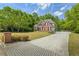 Elegant brick home with a large driveway, lush landscaping, and a serene setting at 1213 Blue Springs Dr, Loganville, GA 30052